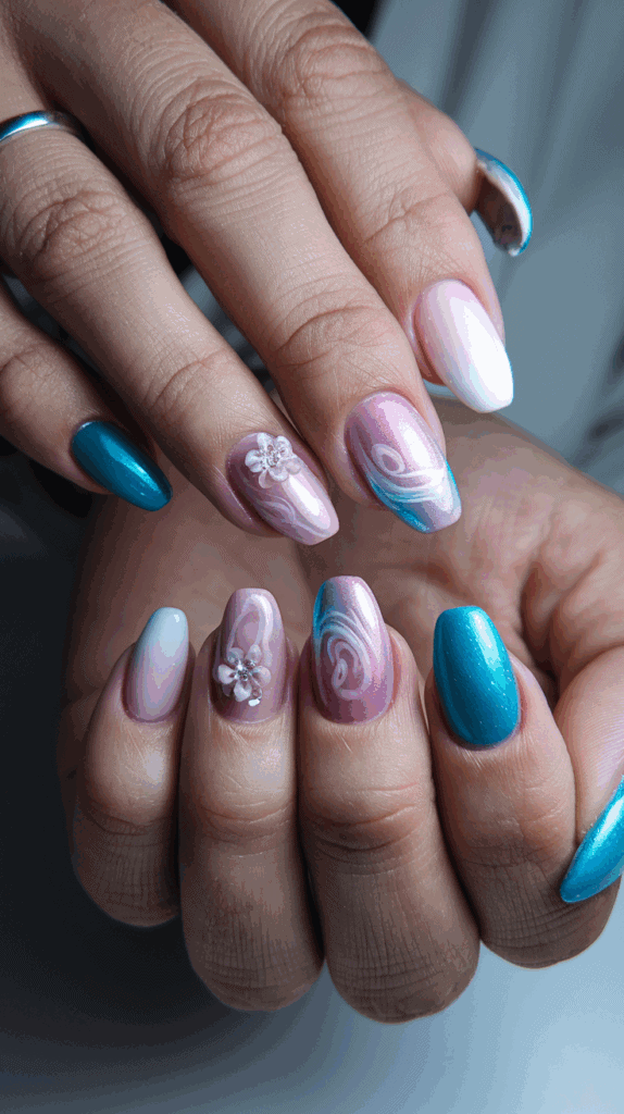 Close-up of hands with manicured nails featuring a mix of blue, pink, and white designs, including floral patterns and swirls.